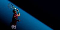 MELBOURNE, AUSTRALIA - JANUARY 19: Rafael Nadal of Spain serves in his second round singles match against Yannick Hanfmann of Germany during day three of the 2022 Australian Open at Melbourne Park on January 19, 2022 in Melbourne, Australia. (Photo by Darrian Traynor/Getty Images)