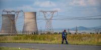An Eskom employee walks home from Grootvlei Power Station in Mpumalanga. (Photo: Julia Evans)