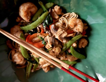 Wok-fried prawn tails with egg noodles and garden tatsoi