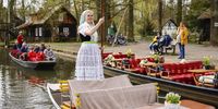 A woman in traditional costume (R) moves her barge for tourists at a canal in the Spreewald region, in Lehde, Germany, 04 April 2024 (issued 08 April 2024). The Spreewald region lies just around 100 kilometers south of Berlin and it has been protected as a UNESCO biosphere reserve since 1991. Cultivation has created a mosaic of small meadows, fields and forests, as well as a network of rivers, used annually from April to October to deliver mail through a nine-meter barge, following a 116-year-old tradition in these wetlands. According to official tourism information, the Spreewald recorded 2.2 million overnight stays in 2023.  EPA-EFE/HANNIBAL HANSCHKE