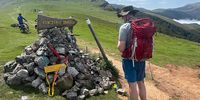 The Husband at a signpost, which doubles up as a shrine, on top of the Pyrenees on the way between St Jean Pied de Port and Roncesvalles, France, 22 August 2023. (Photo: Pauli van Wyk)