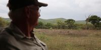 Chris Ransome looks at fence and the green hills of Marakele National Park looming north in the distance. (Photo: Felix Dlangamandla)