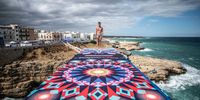 POLIGNANO A MARE, ITALY  - SEPTEMBER 22: (EDITORIAL USE ONLY) In this handout image provided by Red Bull, Aidan Heslop of Great Britain prepares to dive from the 27 metre platform during the final competition day of the fifth stop of the Red Bull Cliff Diving World Series on September 22, 2021 at Polignano a Mare, Italy. (Photo by Dean Treml/Red Bull via Getty Images)