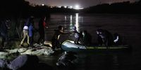 MISSION, TEXAS - MARCH 30:  A group of migrants arrives in the U.S. after crossing the Rio Grande in a raft piloted by smugglers on March 30, 2021 in Roma, Texas. The group, made up of individuals from mostly Central American countries, turned themselves into the U.S. Border Patrol after crossing as they seek asylum in the United States. (Photo by Joe Raedle/Getty Images)