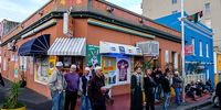 Residents stand outside Rose Corner cafe waiting for the call to break their fasts during Ramadan. Photo: Barry Christianson
