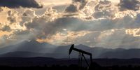 Light from the setting sun shines through clouds over a pumpjack oil well near Loveland on the Niobara shale formation in the United States. (Photo: © Les Stone / Greenpeace)