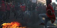 Wits University students march through the streets of Braamfontein destroying rubbish bins. (Photo: Felix Dlangamandla)