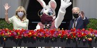 U.S. President Joe Biden, right, and First Lady Jill Biden wave beside a costumed Easter bunny from the Truman Balcony of the White House in Washington, D.C., U.S., on Monday, April 5, 2021. The Biden administration is aiming to corral overwhelming public support for its $2.25 trillion infrastructure plan, targeting Republican voters, independents, mayors, governors and local politicians to counter opposition from GOP lawmakers. Photographer: Michael Reynolds/EPA/Bloomberg via Getty Images
