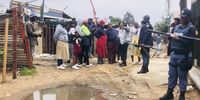 Residents of Kanana watched as police escorted City Power workers into the community to remove illegal cables. (Photo: Silver Sibiya)