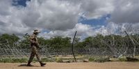 A soldier walks past the infamous R37M border fence which Minister of Home Affairs, Dr. Aaron Motsoaledi called a 'chicken fence' during his visit.<br>Photo / Shiraaz Mohamed.
