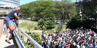 A photographer leaps from a parapet while seeking vantage points to take images of the 250 global climate change scientists meeting in Durban.  Photo: Tony Carnie 