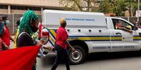 Wits students walk behind the Gauteng Pathology Services van as it removed the body of the bystander killed during student protests.  (Photo: Masego Mafata)