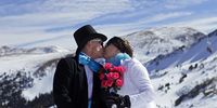 Michael and Marcia Linley of Fort Collins, Co. kiss atop Loveland Ski Area in Colorado prior to the start of the 20th Annual Marry Me &amp; Ski Free Mountaintop Matrimony on Valentine's Day, February 14th in Loveland, Colorado. The mass wedding ceremony was held at noon at 12,050 feet outside of the Ptarmigan Roost Cabin at Loveland. More than 75 couples were pre-registered to get married or renew their vows high on The Continental Divide in this yearly Loveland tradition.  Following the ceremony couples were invited to a casual reception complete with a champagne toast, wedding cake and music. The Linleys are avid skiiers and were renewing their vows after 34 years of marriage. (Photo by Marc Piscotty/Getty Images)
