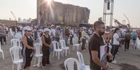 BEIRUT, LEBANON - AUGUST 04: Families of victims of the Beirut Port explosion observe a minute"u2019s silence during an anniversary commemoration on August 4, 2021 in Beirut, Lebanon. Whilst investigations for accountability continue, Lebanese commemorate the 218 people who died and 7 000 injured on August 4, 2020 when 2750 tons of ammonium nitrate exploded in the port of Beirut. The blast, one of the largest non-nuclear explosions in world history, displaced 300,000 people and damaged buildings up to 20km away. (Photo by Sam Tarling/Getty Images)