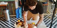 Sebastian Nico plates up for a food shoot at Chef’s Table. (Photo: Joshua Jordan)<br>