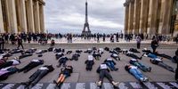  Members of the French women group 'Nous Toutes' (all of us) lay on the ground with  placards reading the names of women killed by feminicide since the election of French President Macron, on the Place du Trocadero, near the Eiffel Tower, in Paris, France, 20 October 2024. Activists demand more government action against gender-based violence.  EPA-EFE/CHRISTOPHE PETIT TESSON