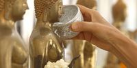 A person pours water on a Buddha statue to mark the Songkran festival, also known as water festival, the traditional Thai New Year celebrations, at a temple in Bangkok, Thailand, 12 April 2024. Thailand celebrates the Thai traditional New Year Songkran festival, also known as the water festival which annually falls on 13 April and is celebrated with splashing water as a symbolic sign of cleansing and washing away the sins and bad luck from the old year. The United Nations Educational, Scientific, and Cultural Organization (UNESCO) inscribed Thailand's Songkran Festival in the list of the Intangible Cultural Heritage of Humanity.  EPA-EFE/NARONG SANGNAK