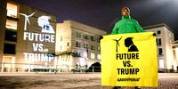 An activist for Greenpeace displays a banner outside the US embassy in Berlin, Germany, on 21 January. (Photo: Clemens Bilan/EPA-EFE)