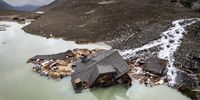 epa12156901 An aerial view shows a destroyed house in the water from the river Lonza after the formation of a lake on the last houses of the village of Blatten, after a massive avalanche, triggered by the collapse of the Birch Glacier, in Blatten, Switzerland, 05 June 2025. A large part of the village of Blatten, located in the Loetschental Valley in the canton of Valais, was buried under masses of ice, mud and rocks. Numerous houses were destroyed, and one person is missing. Between May 19 and 28, several million cubic meters of rock fell from the Kleines Nesthorn mountain above Blatten. This created a nine-million-tonne debris cone on the Birch Glacier, which ultimately collapsed on 28 May 2025.  EPA-EFE/MICHAEL BUHOLZER