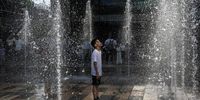 A boy stands in a water fountain as he cools off at a shopping mall during a heat wave on 23 June 2023 in Beijing, China. Authorities issued a red alert for high temperatures, the highest in the country's four-tier system, as China's capital and other parts of northern China saw scorching temperatures hovering around 40 degrees Celsius. (Photo: Kevin Frayer / Getty Images)