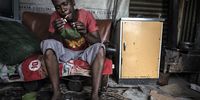That Lephething lights a hand rolled cigarette inside his shack in Qalabotjha Township, Villiers. Lephething says their biggest struggle is that of the lack of electricity and toilets. He has to walk to a nearby field that he uses as a toilet.<br>Daily Maverick / Shiraaz Mohamed