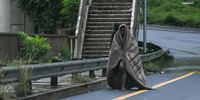 A man walks on the highway on April 12, 2022 in Durban, South Africa. According to media reports, persistent heavy rain in parts of KwaZulu-Natal has resulted in widespread flooding, collapsing roads and death. (Photo by Gallo Images/Darren Stewart)
