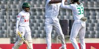 Kagiso Rabada celebrates with Tony de Zorzi after taking the wicket of Bangladesh's Mominul Haque during the second day of their first Test at the Sher-e-Bangla National Cricket Stadium in Dhaka on 22 October 2024. (Photo: Tanvin Tamim / AFP)
