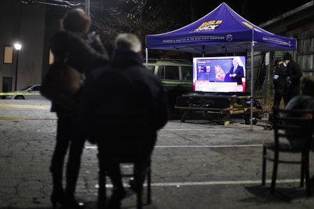 US anxiously awaits Georgia runoff results as protesters descend on Washington DC