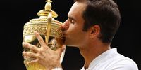 LONDON, ENGLAND - JULY 16:  Roger Federer of Switzerland kisses the trophy as he celebrates victory after the Gentlemen's Singles final against  Marin Cilic of Croatia on day thirteen of the Wimbledon Lawn Tennis Championships at the All England Lawn Tennis and Croquet Club at Wimbledon on July 16, 2017 in London, England.  (Photo by Clive Brunskill/Getty Images)
