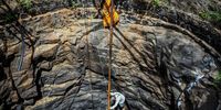 NASHIK, INDIA - MAY 27: Chintaman Yadav (bottom), 60, and Padma Yadav (top), 37, descend along the walls with the aid of ropes into a mostly dry well to fetch water on May 27, 2023 in Gangongdwadi village, Peth Taluka, Nashik, Maharashtra, India. The Indian state of Maharashtra is facing a water crisis of unprecedented scale. Severe drought has taken hold over the inland parts of the state over the last few years; river currents have ebbed. There is less than 10% water available in 13 important reservoirs that supply the state, which is the powerhouse of the Indian economy, local media reports said. Environmental assessments have underscored concerns over the long-term availability of water. A Record number of tankers are the only source of water in large parts of state at present, barely keeping communities heavily reliant on predictable weather patterns for their livelihoods. (Photo by Ritesh Shukla/Getty Images)