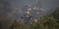 A firefighter carries a hose in Walmer Estate, Cape Town on 19 April 2021. (Photo: Leila Dougan)