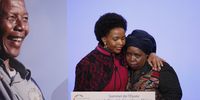 South African Minister for International Relations and Cooperation Maite Nkoana-Mashabane (left) embraces then-Chairperson of the African Union Commission Nkosazana Dlamini Zuma (right), next to the portrait of Nelson Mandela, as part as the Elysee Summit for Peace and Security in Africa at the Elysee Palace in Paris, France on 6 December, 2013. (Photo: EPA/Yoan Valat)