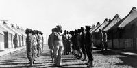 African-American soldiers stand at attention between barracks during World War 2 at Camp Claiborne, Louisiana, 1942. US Army Signal Corps photo. (Photo by Afro American Newspapers/Gado/Getty Images)