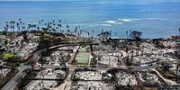 LAHAINA, HAWAII - OCTOBER 09: In an aerial view, a recovery vehicle drives past burned structures and cars two months after a devastating wildfire on October 09, 2023 in Lahaina, Hawaii. The wind-whipped wildfire on August 8th killed at least 98 people while displacing thousands more and destroying over 2,000 buildings in the historic town, most of which were homes. A phased reopening of tourist resort areas in west Maui began October 8th on the two-month anniversary of the deadliest wildfire in modern U.S. history. (Photo by Mario Tama/Getty Images)