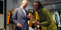 Foday Dumbuya, founder and creative director of LABRUM London, winner of the Queen Elizabeth II Design Award, presents King Charles III with a statuette during a special industry showcase event hosted by the British Fashion Council (BFC) at 180 Studios during BFC Impact Day 2023 on May 18, 2023 in London, England. (Photo by Jonathan Brady-WPA Pool/Getty Images)