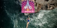 POLIGNANO A MARE, ITALY  - SEPTEMBER 22: (EDITORIAL USE ONLY) In this handout image provided by Red Bull, Meili Carpenter of the United States dives from the 21 metre platform during the final competition day of the fifth stop of the Red Bull Cliff Diving World Series on September 22, 2021 at Polignano a Mare, Italy. (Photo by Dean Treml/Red Bull via Getty Images)