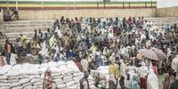 People who fled the war from May Tsemre, Addi Arkay and Zarima gather around in a temporarily built internally displaced people (IDP) camp to receive their first bags of wheat from the World Food Programme (WFP) in Debark, 90 kilometres of the city of Gondar, Ethiopia, on September 15, 2021. (Photo by Amanuel Sileshi / AFP)