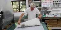 Mark Attwood working on prints.  (Photo: The Artists’ Press)