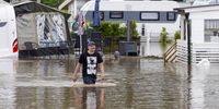 A person walks past camper vans under water on Beveroya in Telemark, Norway, 22 July 2024, following heavy rains in the last 24 hours.  EPA-EFE/Ole Berg-Rusten  NORWAY OUT