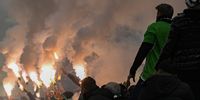 Fans of Haifa hold flares during the men’s soccer UEFA Europa Conference League knock-out round play-offs, 1st leg match between Maccabi Haifa of Israel and KAA Gent of Belgium in Bozsik Arena in Budapest, Hungary, 15 February 2024.  EPA-EFE/Zsolt Szigetvary HUNGARY OUT