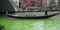 A gondolier propels a gondola along a patch of phosphorescent green liquid seen on the Grand Canal near the Rialto Bridge, in Venice, Italy, 28 May 2023. On the morning of 28 May a patch of phosphorescent green liquid appeared in the waters of Venice, along the Grand Canal near the Rialto Bridge. Firefighters took water samples, while an urgent meeting between the police forces of the city was convened by the Prefect of Venice, as the cause is still unknown.  EPA-EFE/ANDREA MEROLA