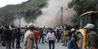 epa09960440 People run to safety as landslide hits near ongoing rescue operation site in Ramban district, south of Srinagar, the summer capital of Indian Kashmir, 20 May 2022. According to the government official in disaster management department, 10 workers were trapped after part of a tunnel collapsed.  EPA-EFE/FAROOQ KHAN