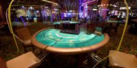LAS VEGAS, NEVADA - APRIL 29:  Prototype clear acrylic safety shield dividers made by Las Vegas-based Screaming Images are tested at a blackjack table at the El Cortez Hotel &amp; Casino, which is closed as a result of the statewide shutdown due to the continuing spread of the coronavirus, on April 29, 2020 in Las Vegas, Nevada. The company, which usually works on large-scale graphic designs and installations for customers like Las Vegas hotel-casinos, decided to try making the recyclable shields for various table games and slot machines to help protect employees and customers once businesses in the state are allowed to reopen. The World Health Organization declared the coronavirus (COVID-19) a pandemic on March 11th.  (Photo by Ethan Miller/Getty Images)
