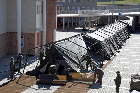 Spain extends coronavirus lockdown, in 'war' to buy medical supplies