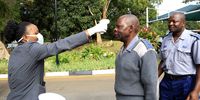 A health officer checks a temperature of a police officer (C) before Zimbabwe's President Emmerson Mnangagwa speech at the launch of the Covid -19  Preparedness and Response Plan at the State House in Harare, Zimbabwe, 19 March 2020. There is no confirmed case of COVID-19 in Zimbabwe yet. Countries around the world are taking increased measures to prevent the wide spread of the SARS-CoV-2 Coronavirus causing the Covid-19 disease.(Photo:  EPA-EFE/AARON UFUMELI)