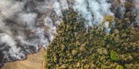 Smoke rises above farm and environmentally protected land while on fire near Sao Jose do Rio Pardo, Sao Paulo state, Brazil, on Tuesday, Aug. 24, 2021. Extreme weather is slamming crops across the globe, bringing with it the threat of further food inflation at a time costs are already hovering near the highest in a decade and hunger is on the rise. Photographer: Jonne Roriz/Bloomberg via Getty Images