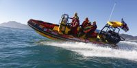National Sea Rescue Institute personnel simulate a rescue during a training session in Kommetjie, Cape Town. (Photo: EPA / Nic Bothma)