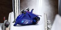 YANQING, CHINA - FEBRUARY 15:  Brad Hall and Nick Gleeson of Team Great Britain crash during the 2-man Bobsleigh Heat 3 on day 11 of Beijing 2022 Winter Olympic Games at National Sliding Centre on February 15, 2022 in Yanqing, China. (Photo by Alex Pantling/Getty Images)