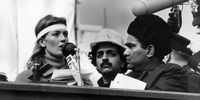 Tariq Ali (middle) stands as English actress Vanessa Redgrave speaks at a demonstration outside the American Embassy, London, at an anti-Vietnam War rally. (Photo: Fox Photos / Getty Images)