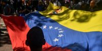 Government supporters wave a Venezuelan flag during a protest against the capture of former president Nicolás Maduro and his wife, Cilia Flores on 8 January 2026 in Caracas, Venezuela. (Photo: Carlos Becerra / Getty Images)